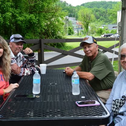 Friends sharing a meal at a picnic table